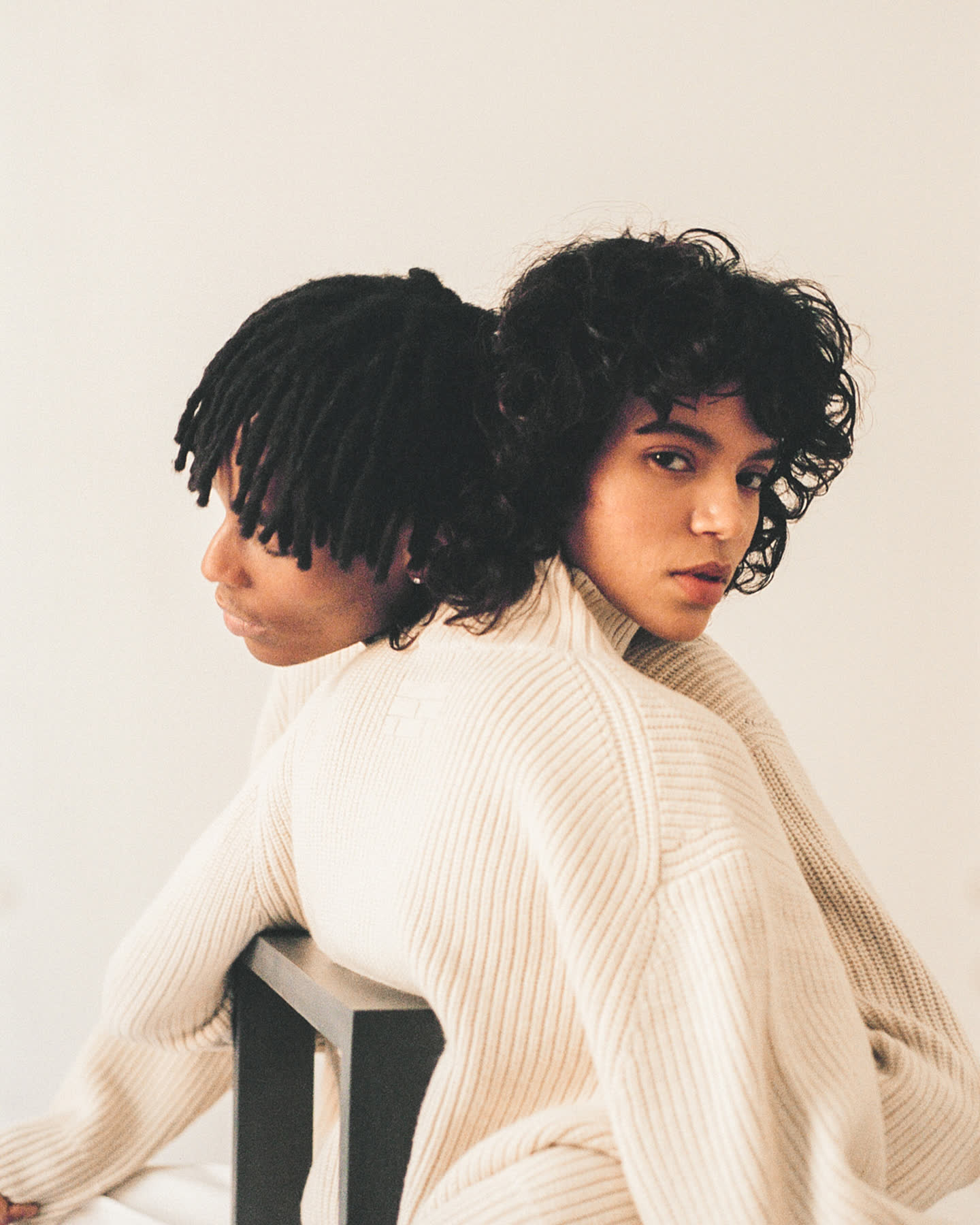 Two models in cream rib knit posed together for À deux by Frame.