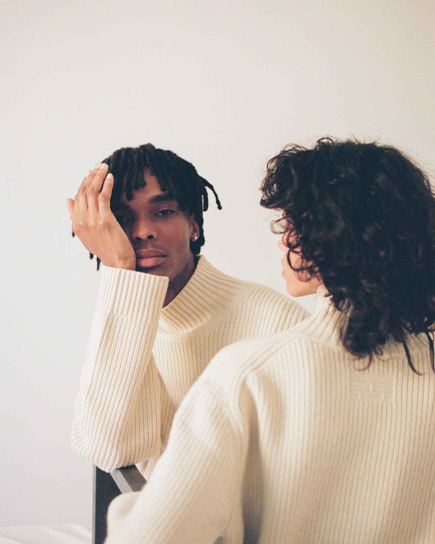 Two models in cream rib knit posed together for À deux by Frame.