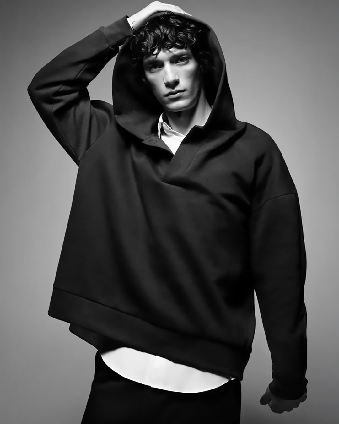 Model in a black hooded sweatshirt photographed for The Bauhaus.