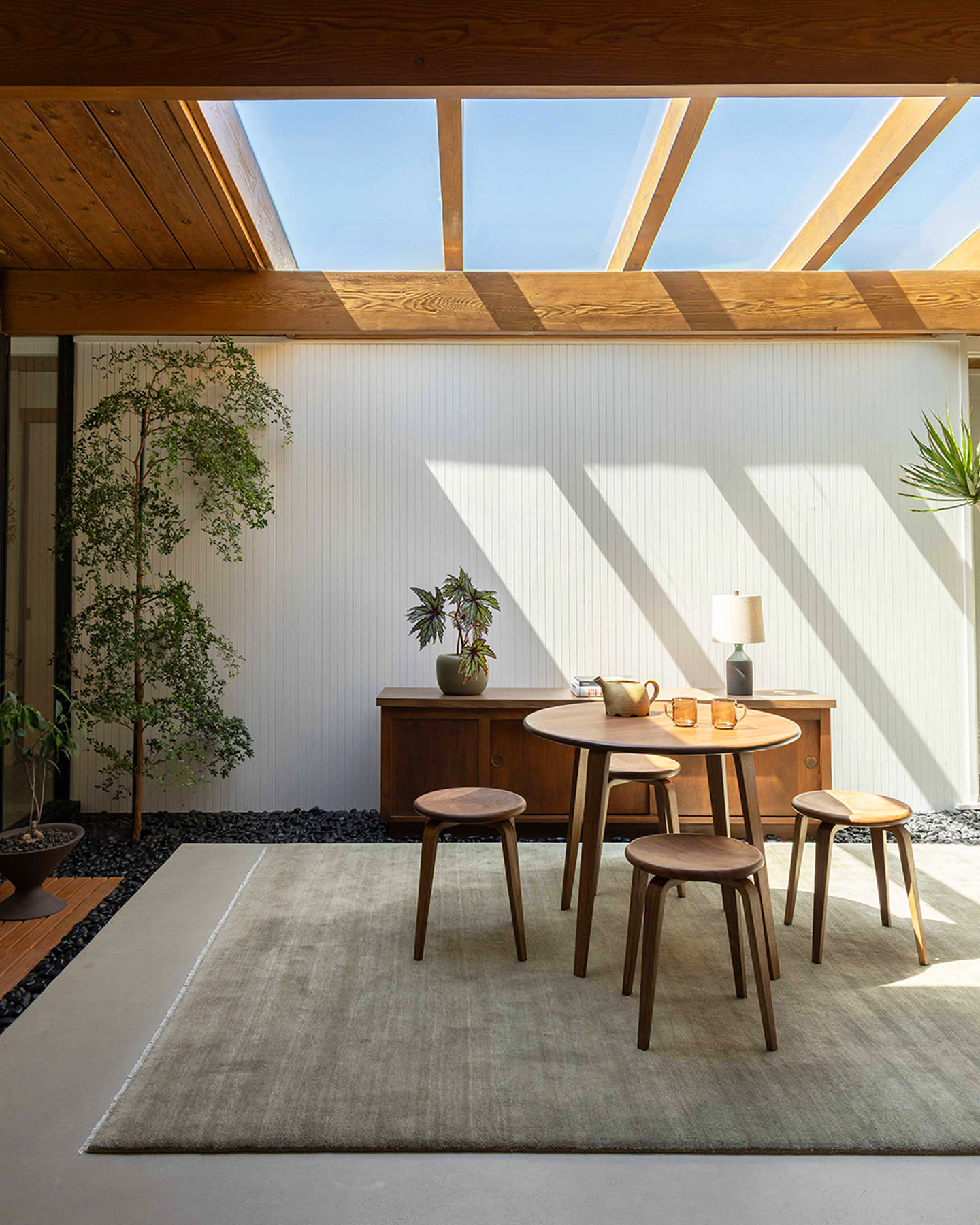 The Bistro Collection table and stools beneath a skylight.