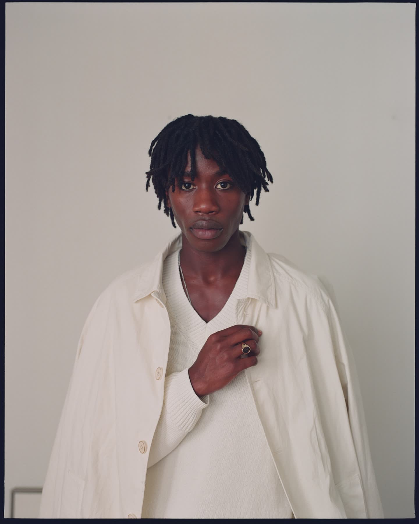 Portrait of Cheikh Tall in a cream knit and coat for Zara.