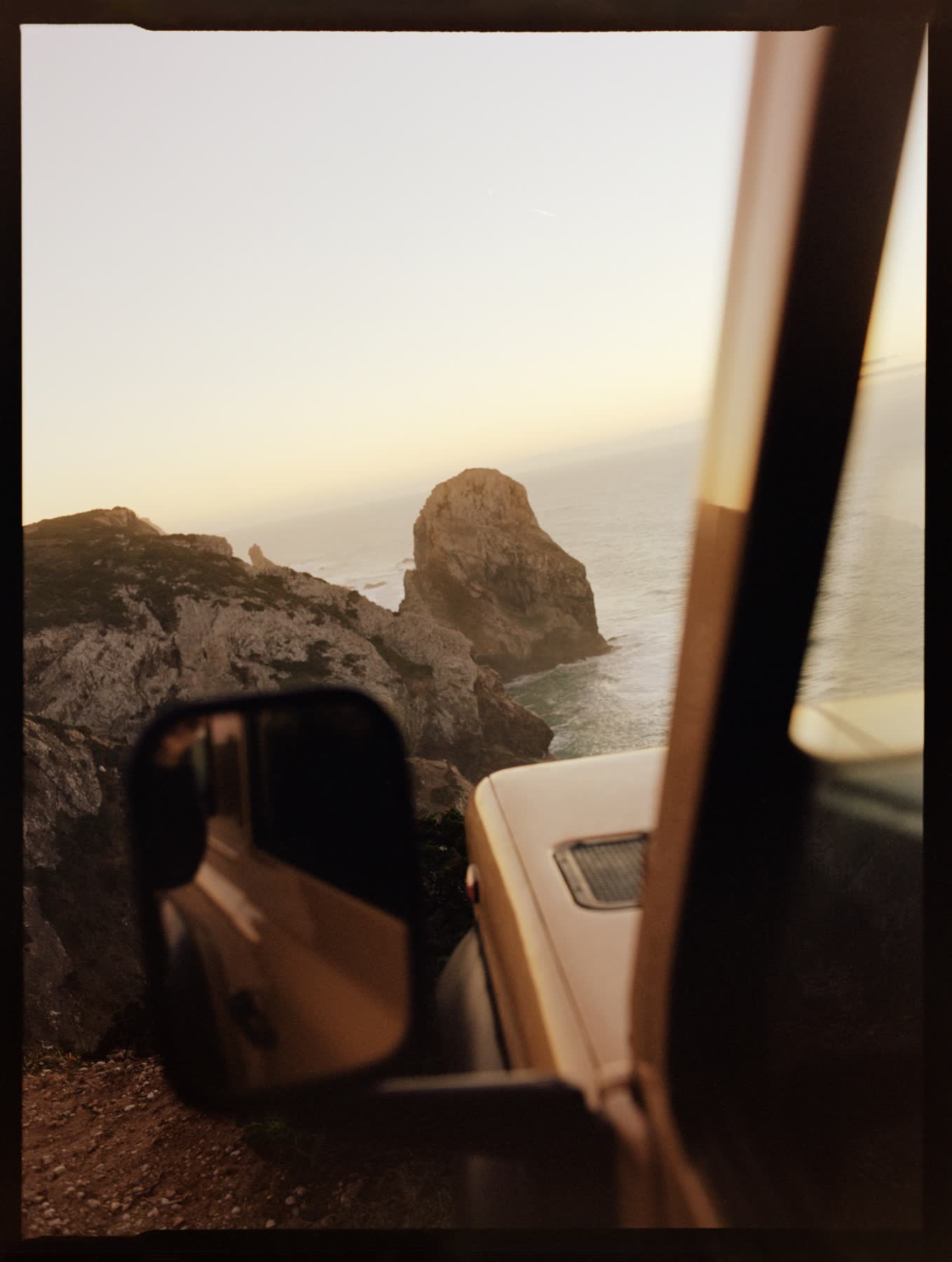 A view of the Atlantic cliffs through the yellow vehicle at Cabo da Roca.