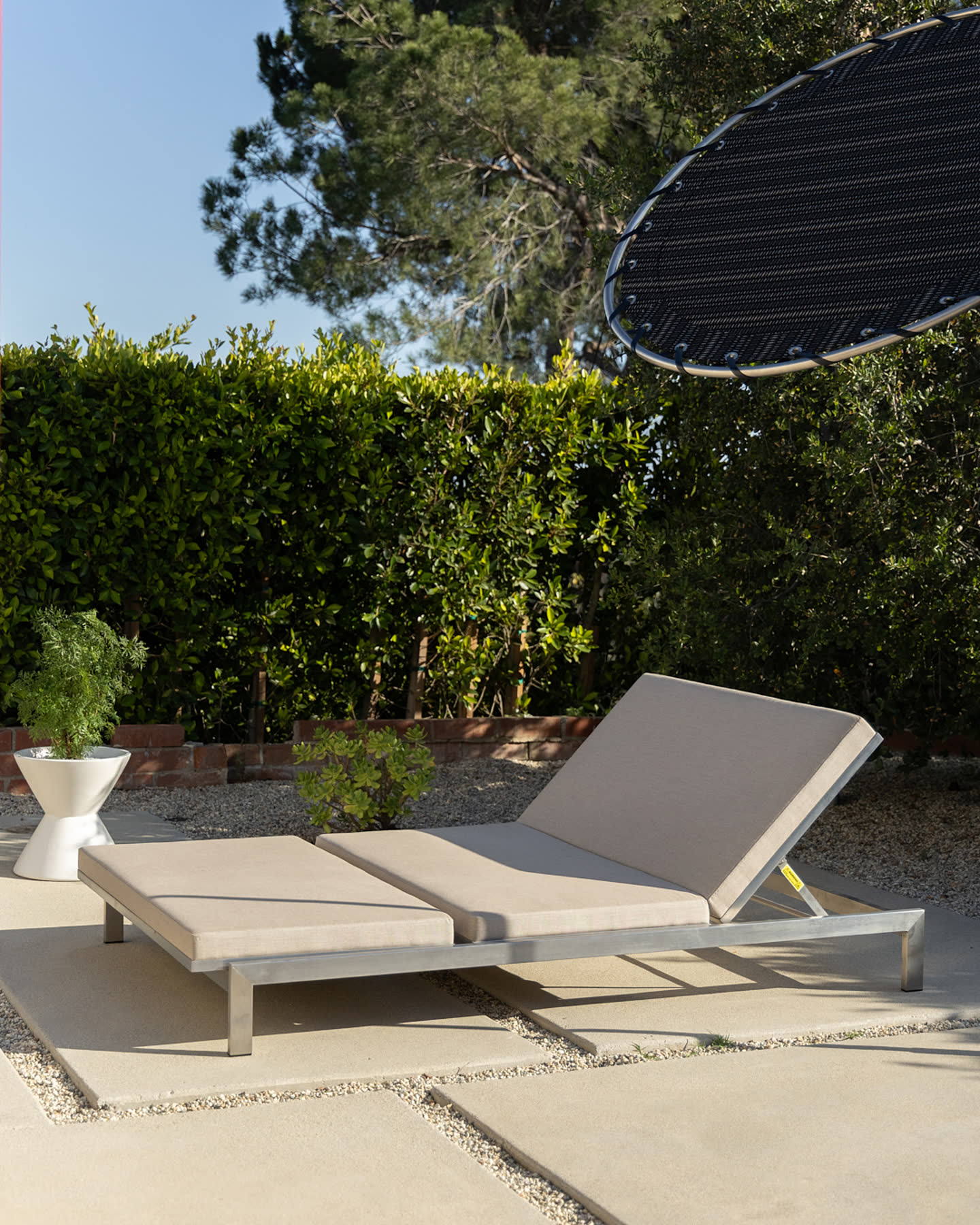 A Modernica daybed in the planted courtyard.