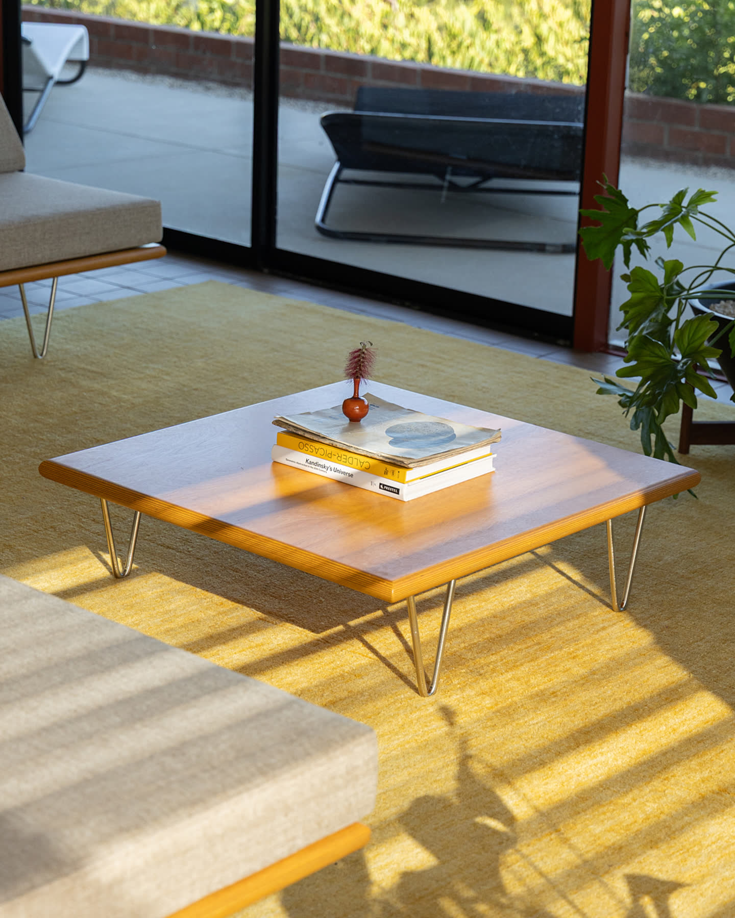 A walnut coffee table with books in the living room.