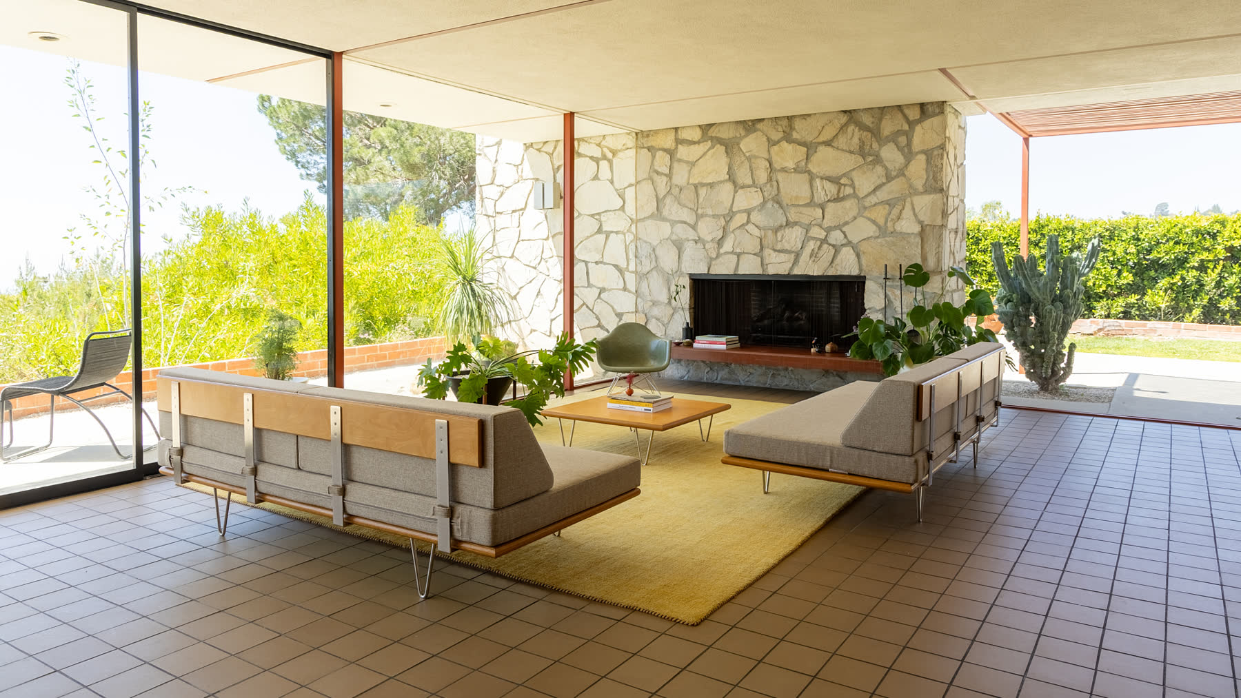 The living room and natural stone fireplace at Case Study House #16.