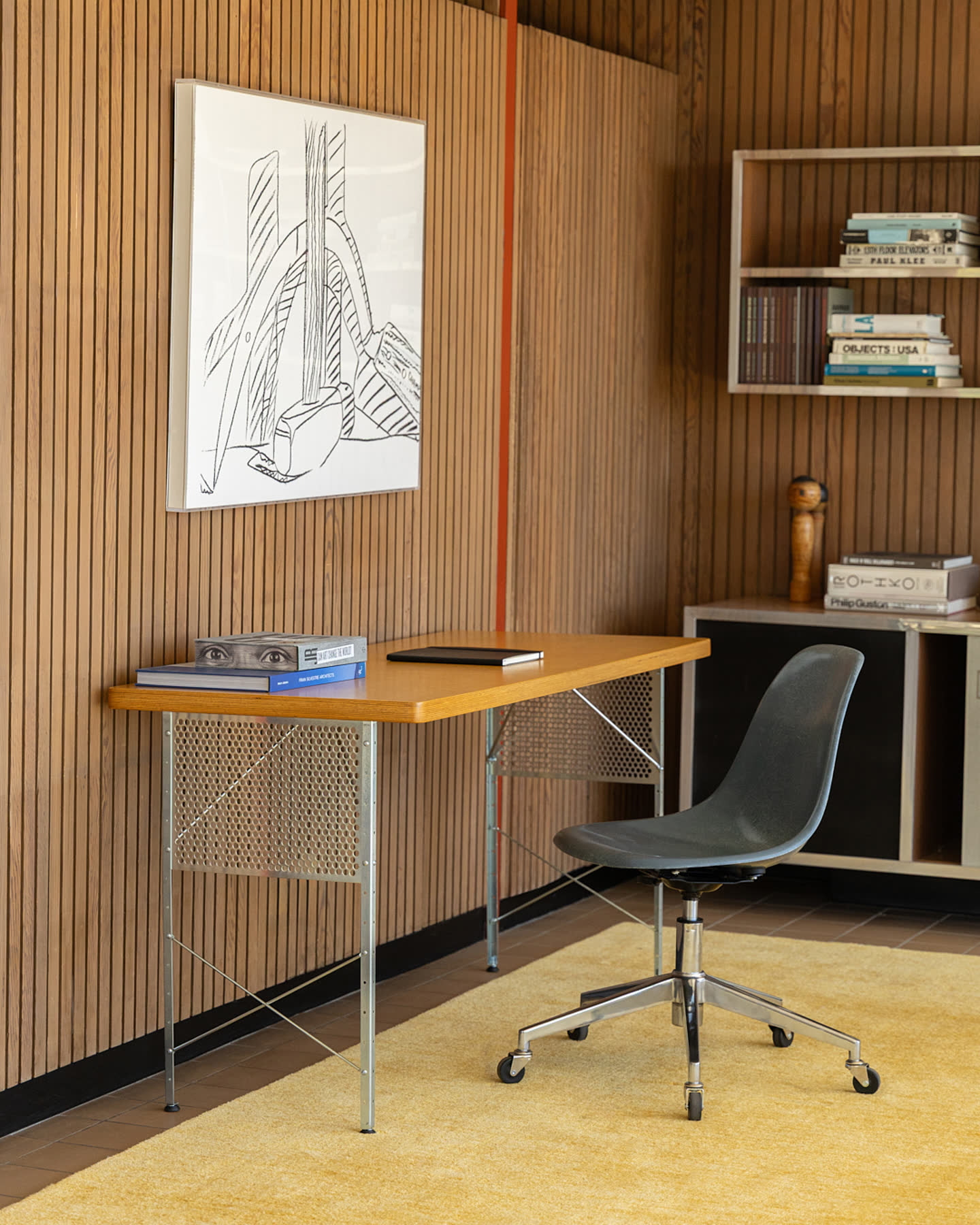 A Modernica desk and chair in the wood-paneled study.