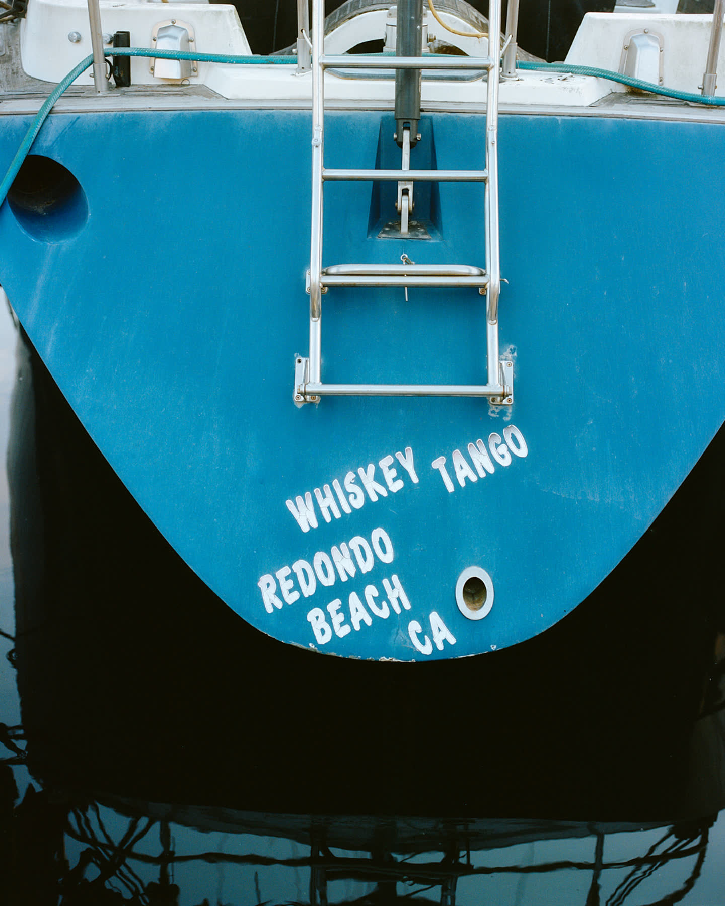 The stern of a blue fishing boat in Catalina Island for Zara.