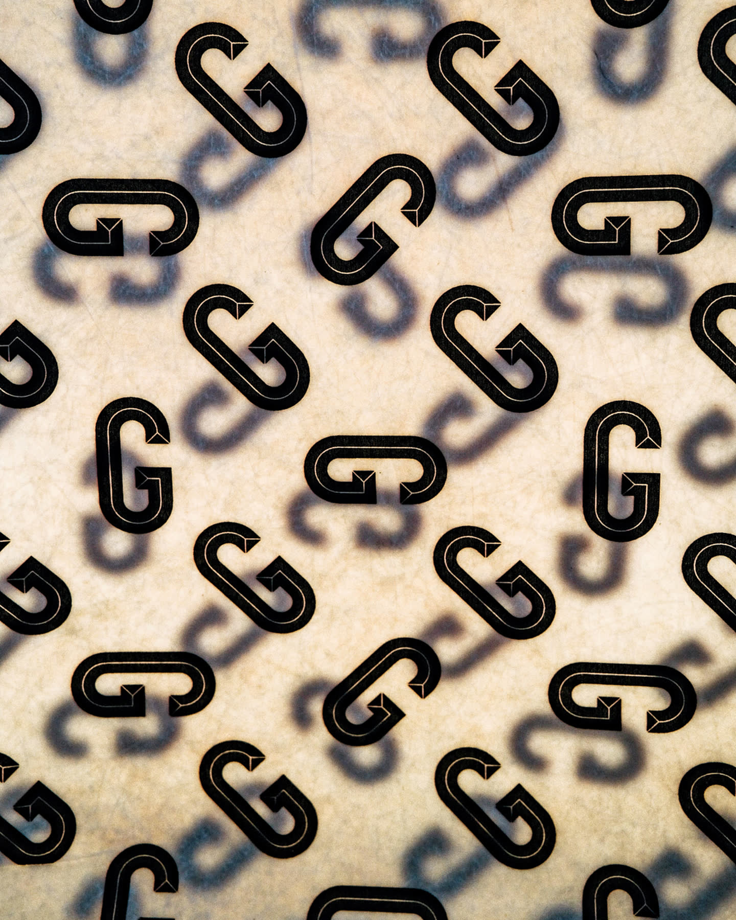 Close detail of the repeating Goudron logo on a chair for Cité Radieuse.