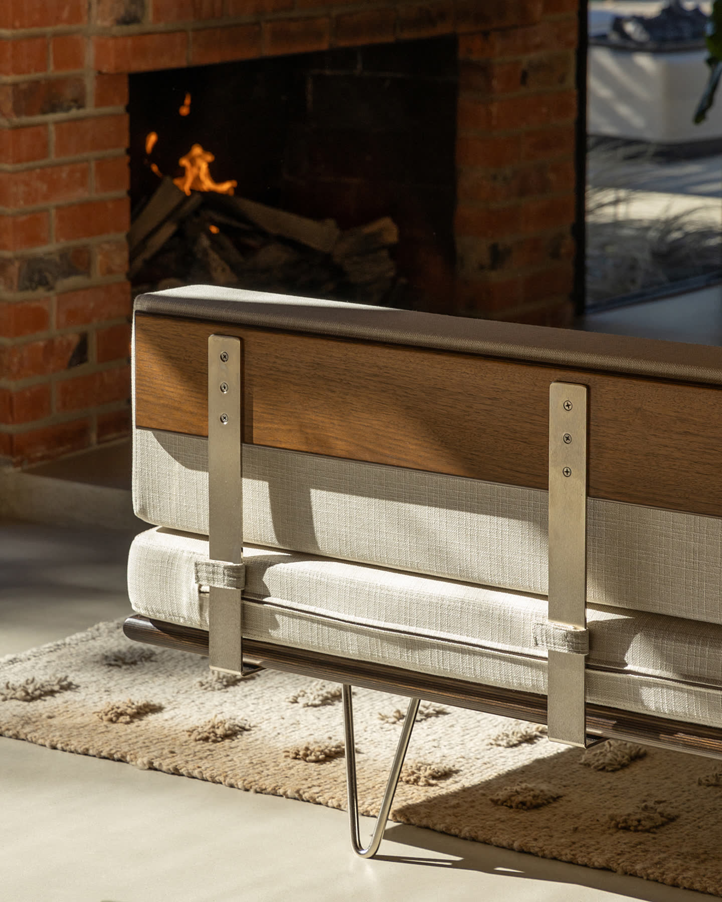 The back of a Modernica sofa beside the Eichler Post & Beam fireplace.