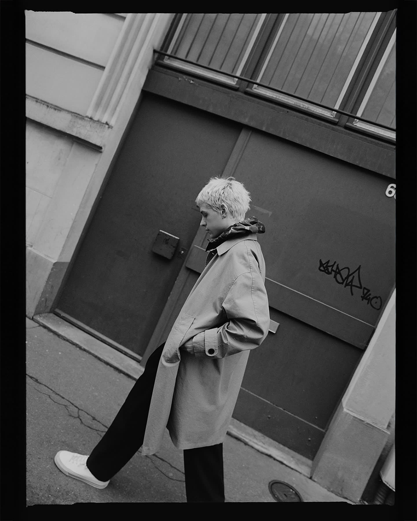 Henri Pier walking through a Paris street in winter for Flâneur.