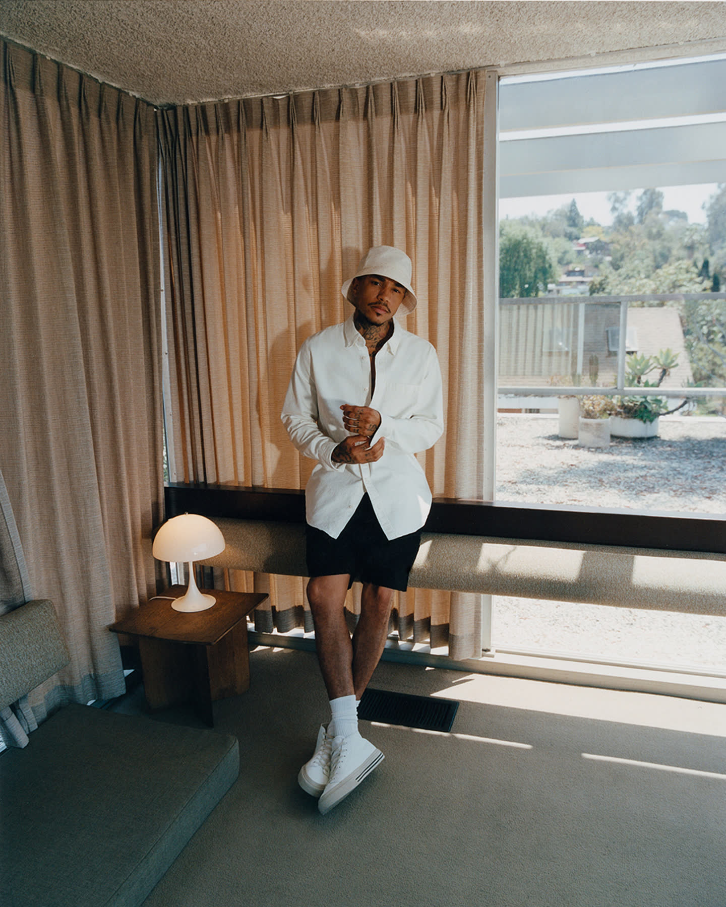 Sean Lyles standing inside the Neutra VDL House for Zara.