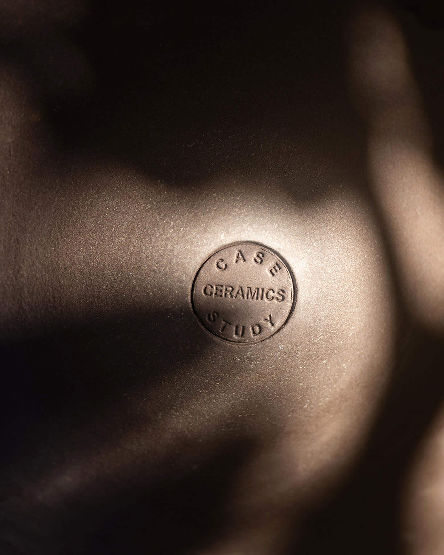 Detail of the Oblique planter&rsquo;s hand-finished ceramic surface and maker&rsquo;s mark.