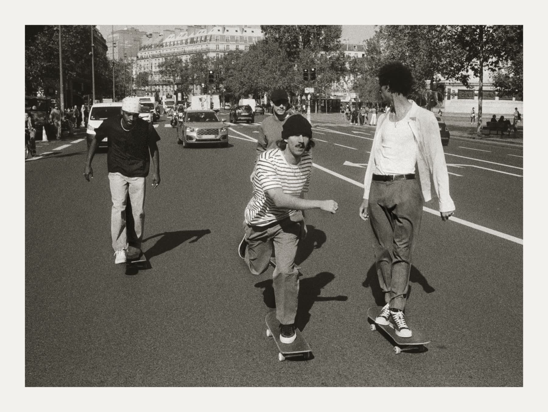 Skateboarders crossing a Paris boulevard near République.