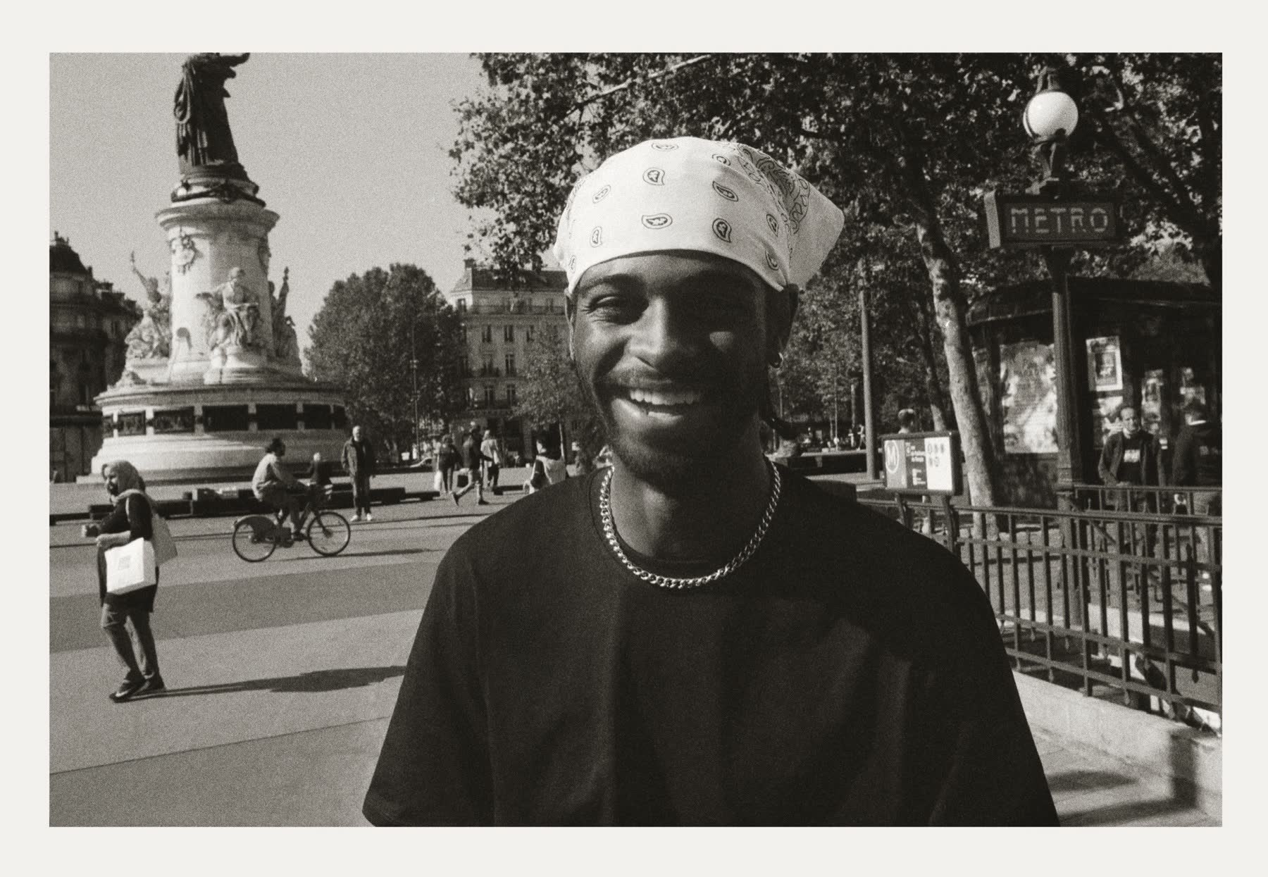 A smiling skater in front of the République metro entrance.