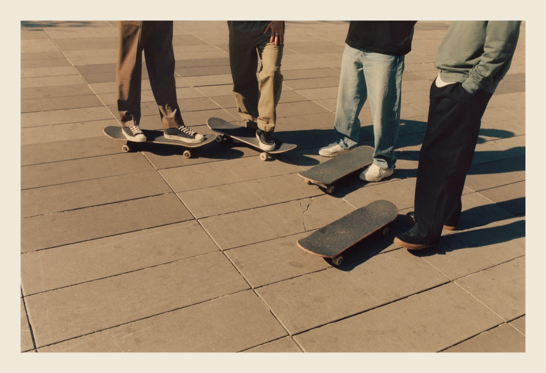 Skateboards and feet gathered on the stone pavers of République.