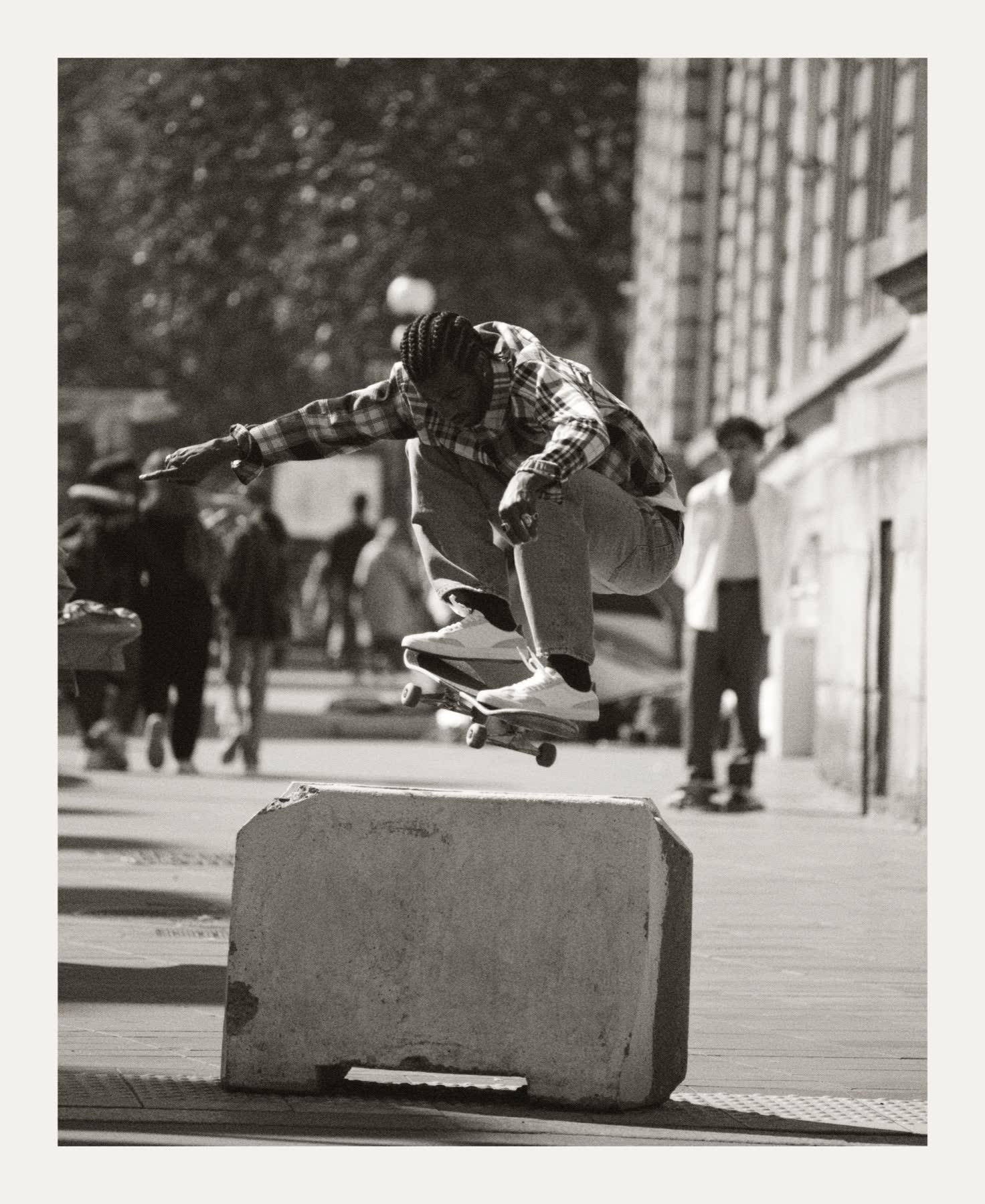 A skater airborne above a city street.