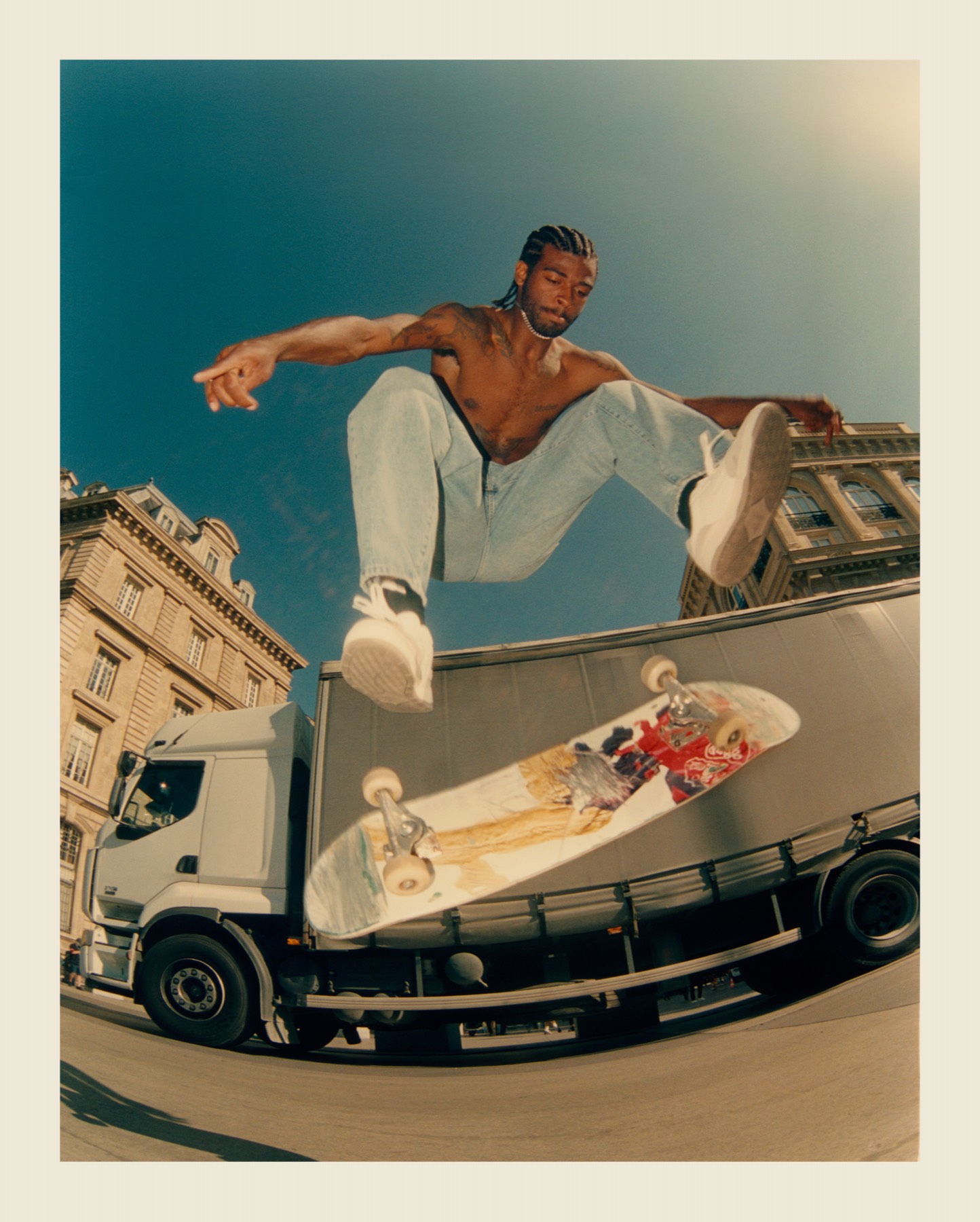 A skateboarder jumping above a Paris street.