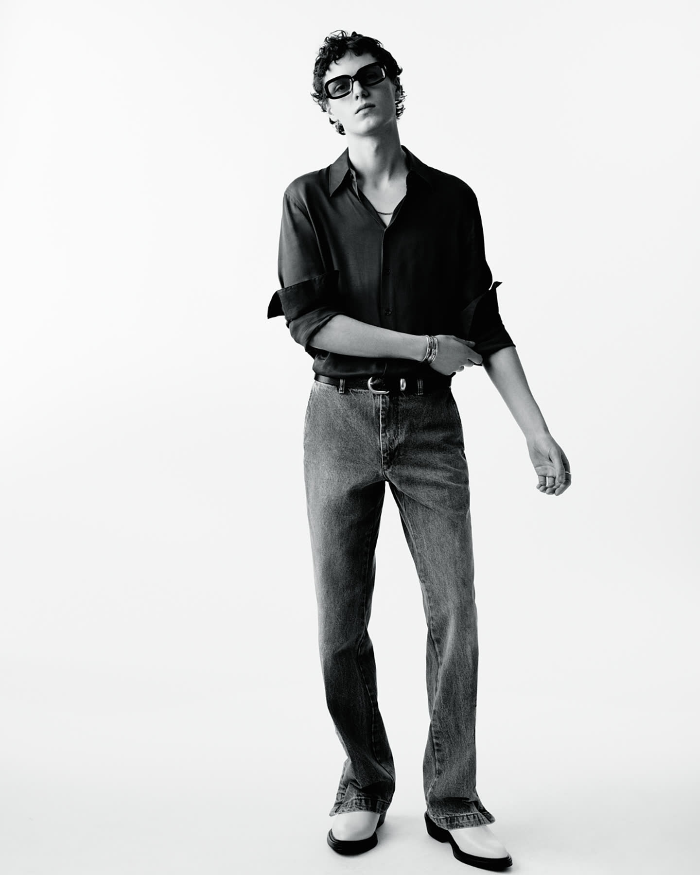A model standing in black silk against a white studio backdrop for Zara.