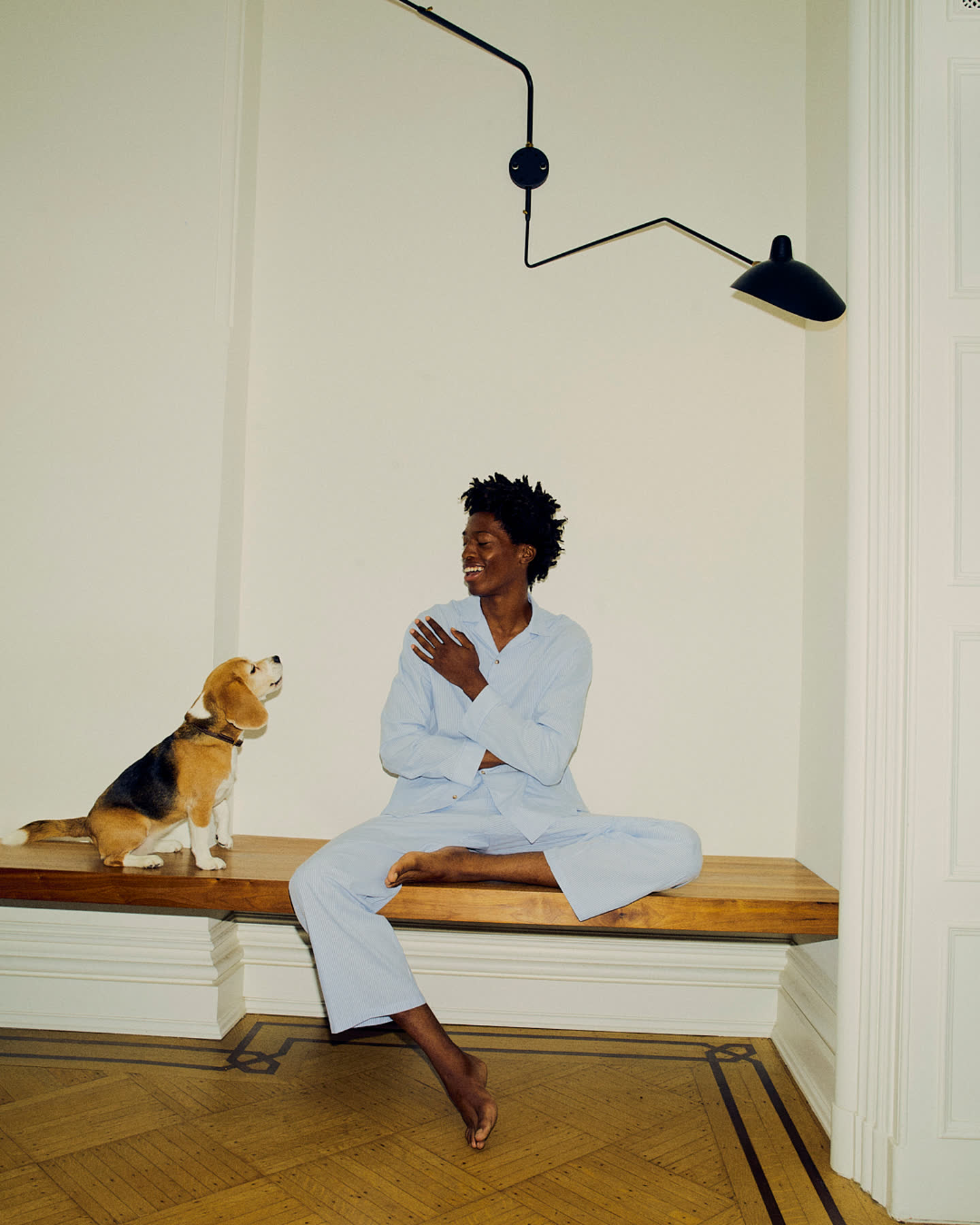 Tamel Lee smiling beside the dog in the morning light.