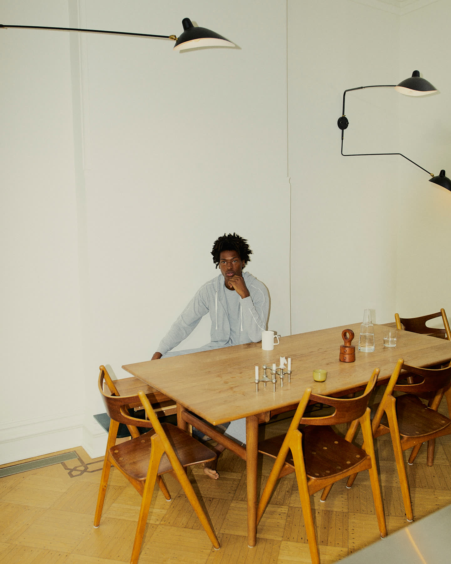 Tamel Lee seated at a dining table in a bright home.