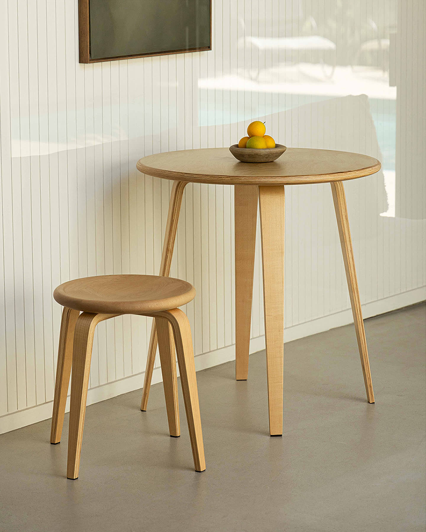 The maple Bistro Collection table and stool in a sunlit interior for Sunroom.