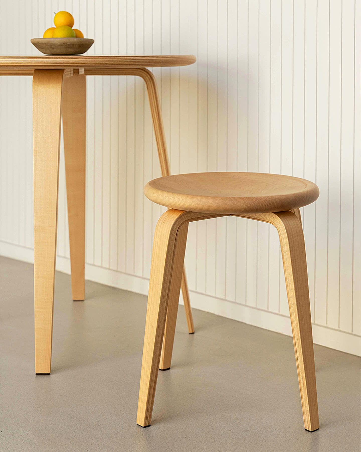 The maple Bistro Collection table and stool in a bright interior for Sunroom.