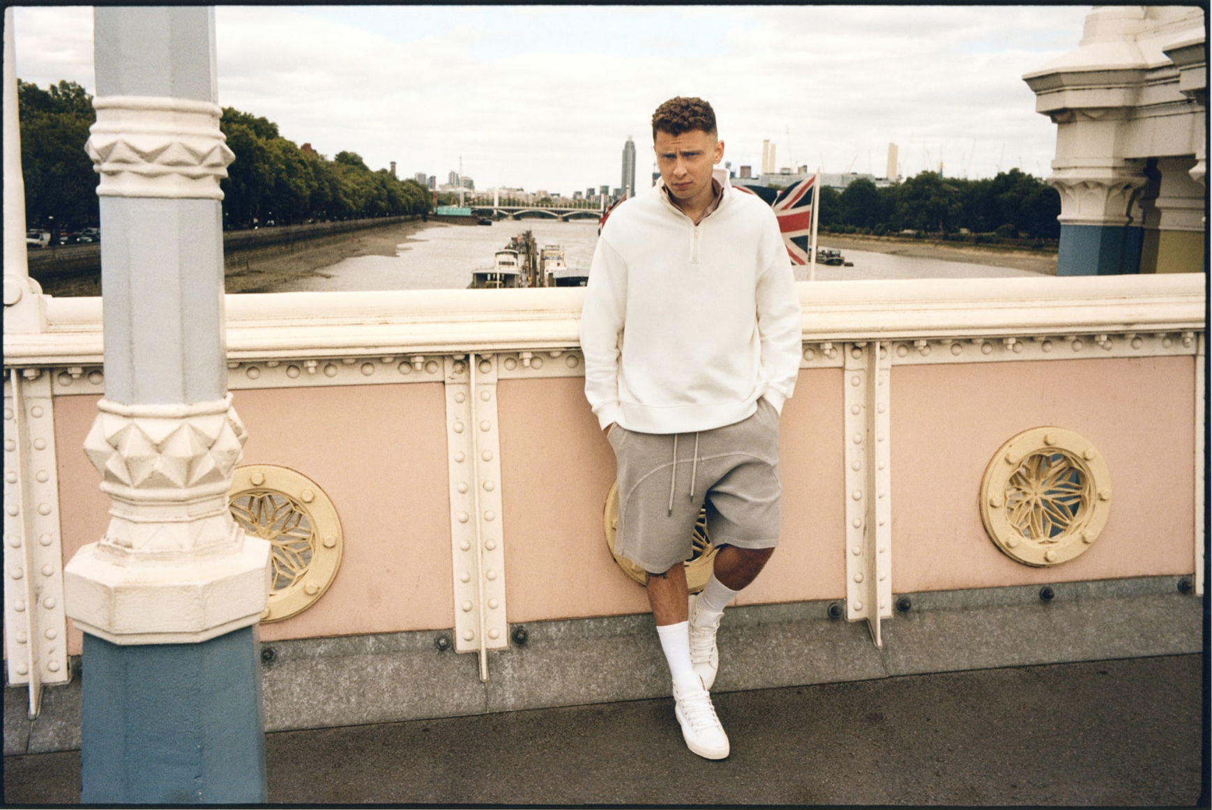 Blondey McCoy standing on a bridge above the Thames for Zara.